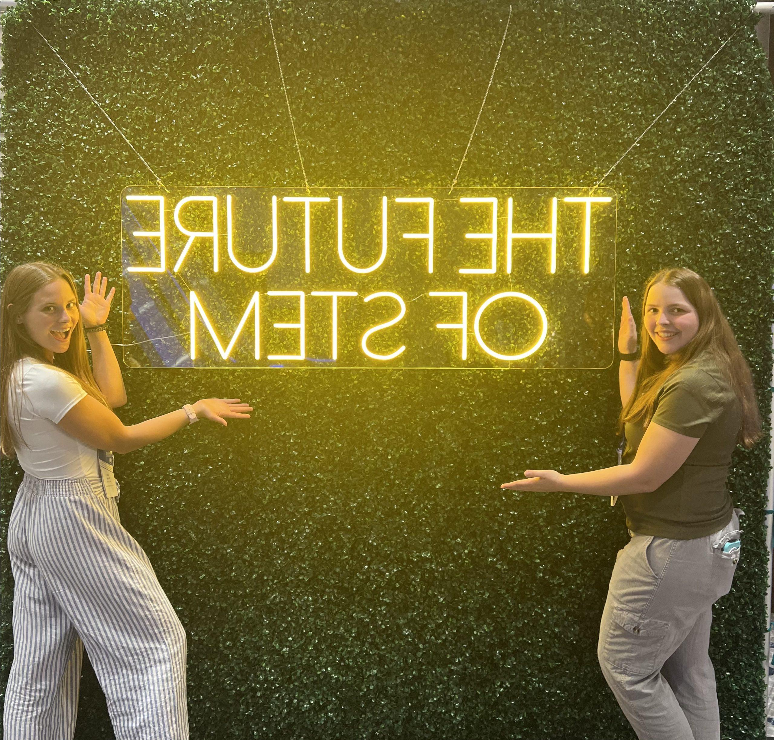 Two students standing under a The Future of Stem sign